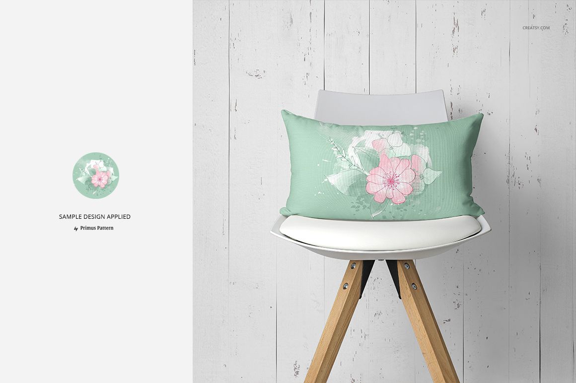 PSD mockup showing a decorative pillow with a soft green cover and large pink flower, displayed on a modern chair.