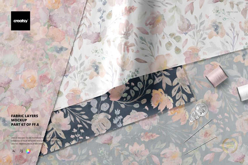 Fabric mockup displaying layered textiles in muted flower prints, surrounded by sewing items on a flat surface.