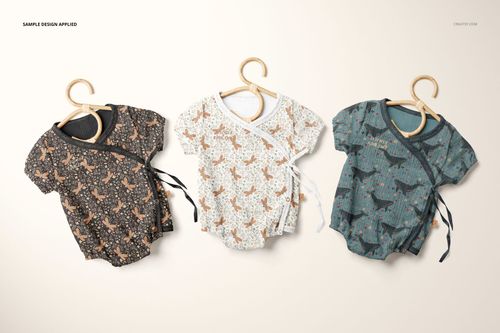 PSD mockup showing three baby muslin onesies with unique prints, arranged side by side against a light background.