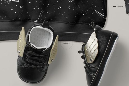 Black baby sweatshirt mockup with space-themed white pattern, shown with black baby shoes featuring gold wings.