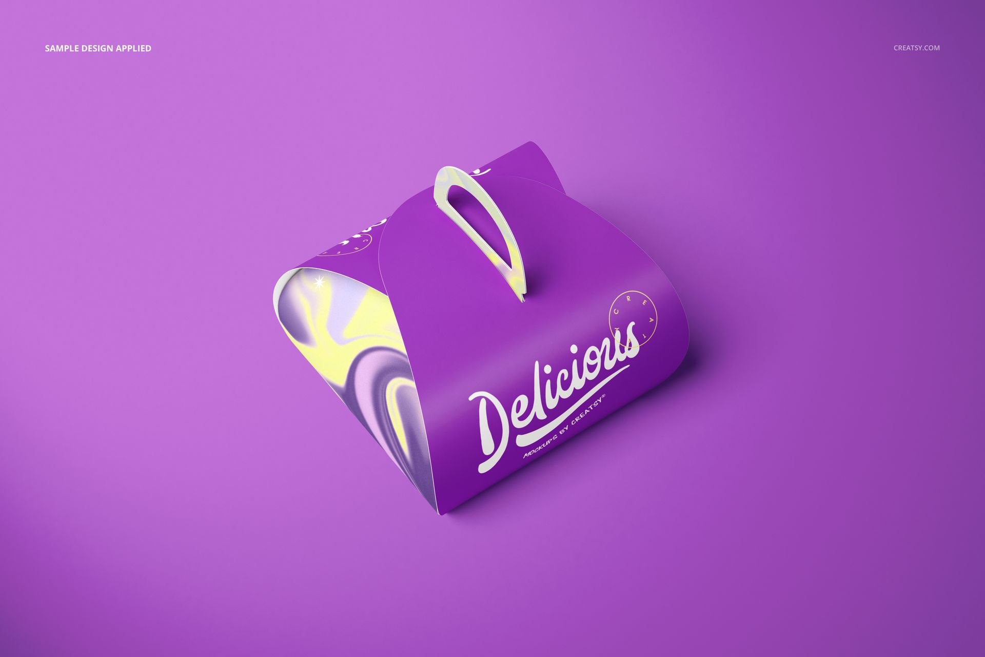 Purple curved cake box mockup with a white handle and bold lettering, displayed on a solid purple background.