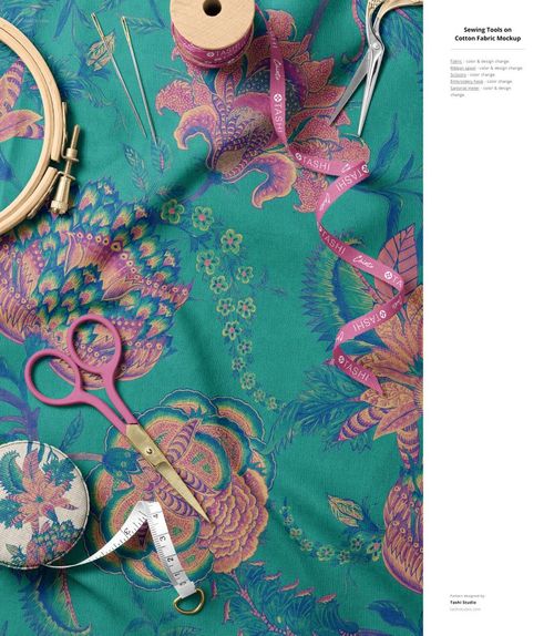 Cotton fabric mockup featuring a colorful floral design, sewing accessories, and crafting tools arranged overhead.