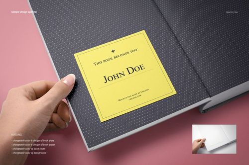 Bookplate mockup showing a yellow rectangular label on the inner cover of a book, viewed from above on a pink desk.