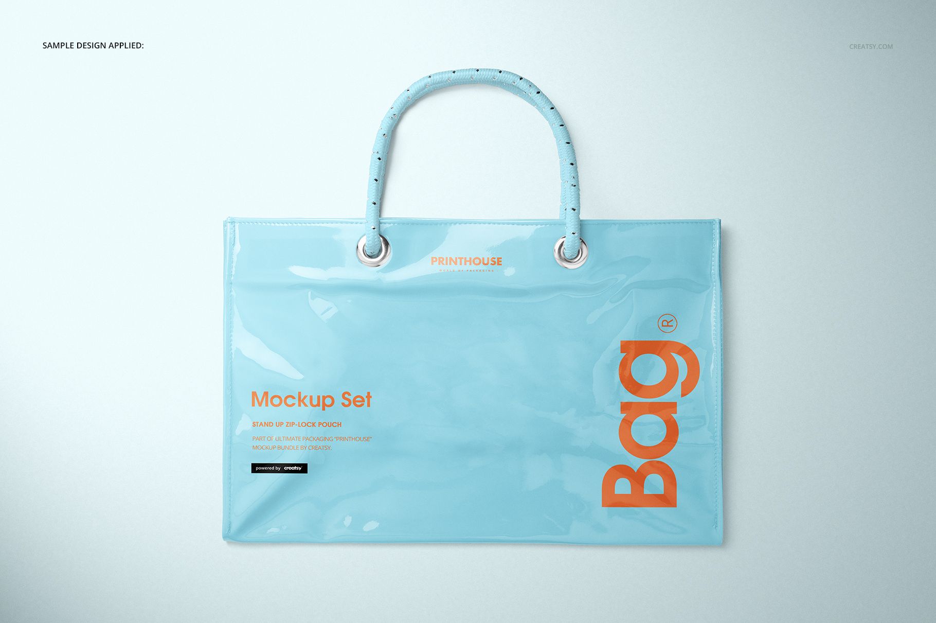 Vinyl PVC tote bag mockup in pastel blue, featuring glossy finish and orange lettering, shown from the front.