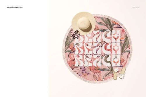 Tassel fringe round towel mockup with tropical pink flowers and white BEACH lettering, shown from above with hat and sandals.