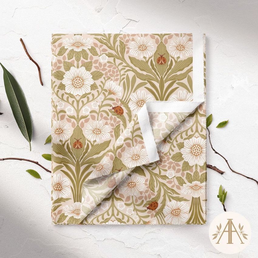 Folded fabric mockup featuring a floral pattern with large white flowers and green leaves on a light background, shown from above.