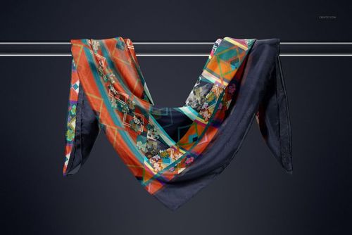 Silk scarf mockup draped over a metal rod, featuring geometric patterns in orange, navy, and teal hues.