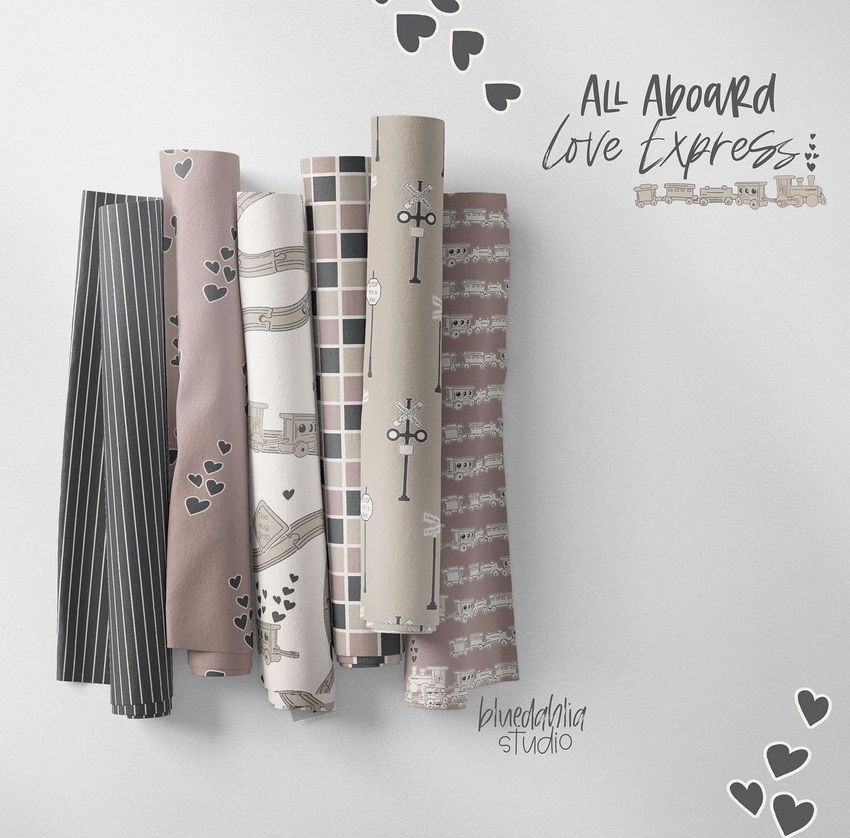 Fabric rolls mockup showing five patterned rolls in soft pink, beige, and gray tones, arranged on a light surface with heart and train motifs.