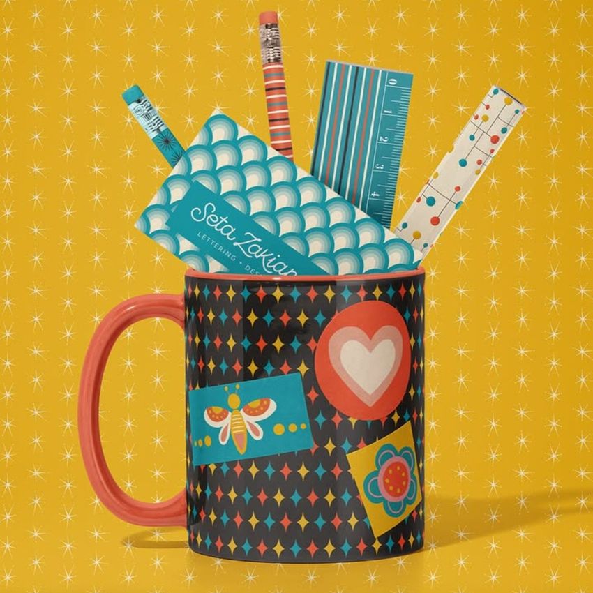Mug mockup with colorful geometric patterns, filled with assorted office supplies like pencils and rulers, on a yellow patterned background.