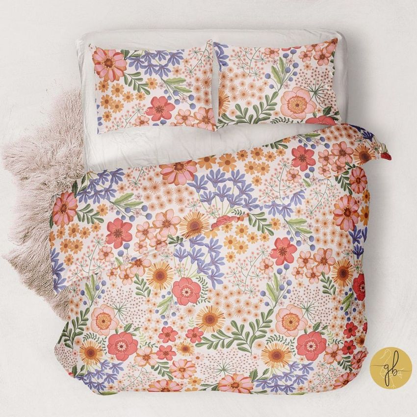 Double bed bedding mockup featuring a duvet and pillows with a colorful floral pattern, viewed from above on a white background.