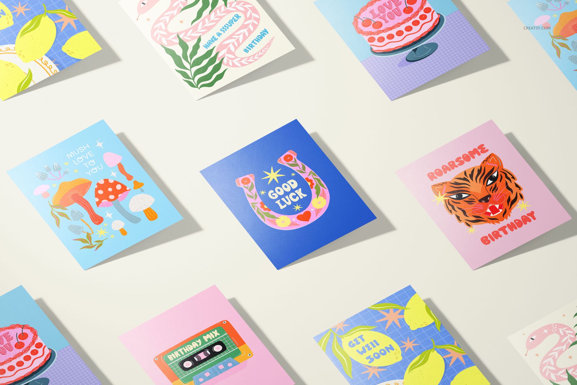 A5 cards mockup set featuring nine colorful greeting cards with various illustrated designs, viewed from above.