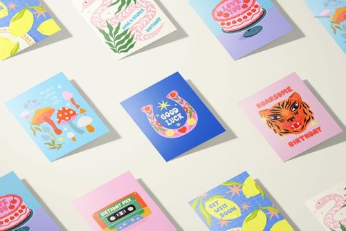 A5 cards mockup set featuring nine colorful greeting cards with various illustrated designs, viewed from above.