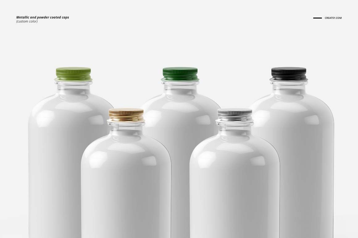 PSD mockup showing five glass bottles with glossy white surfaces and different colored caps on a plain background.