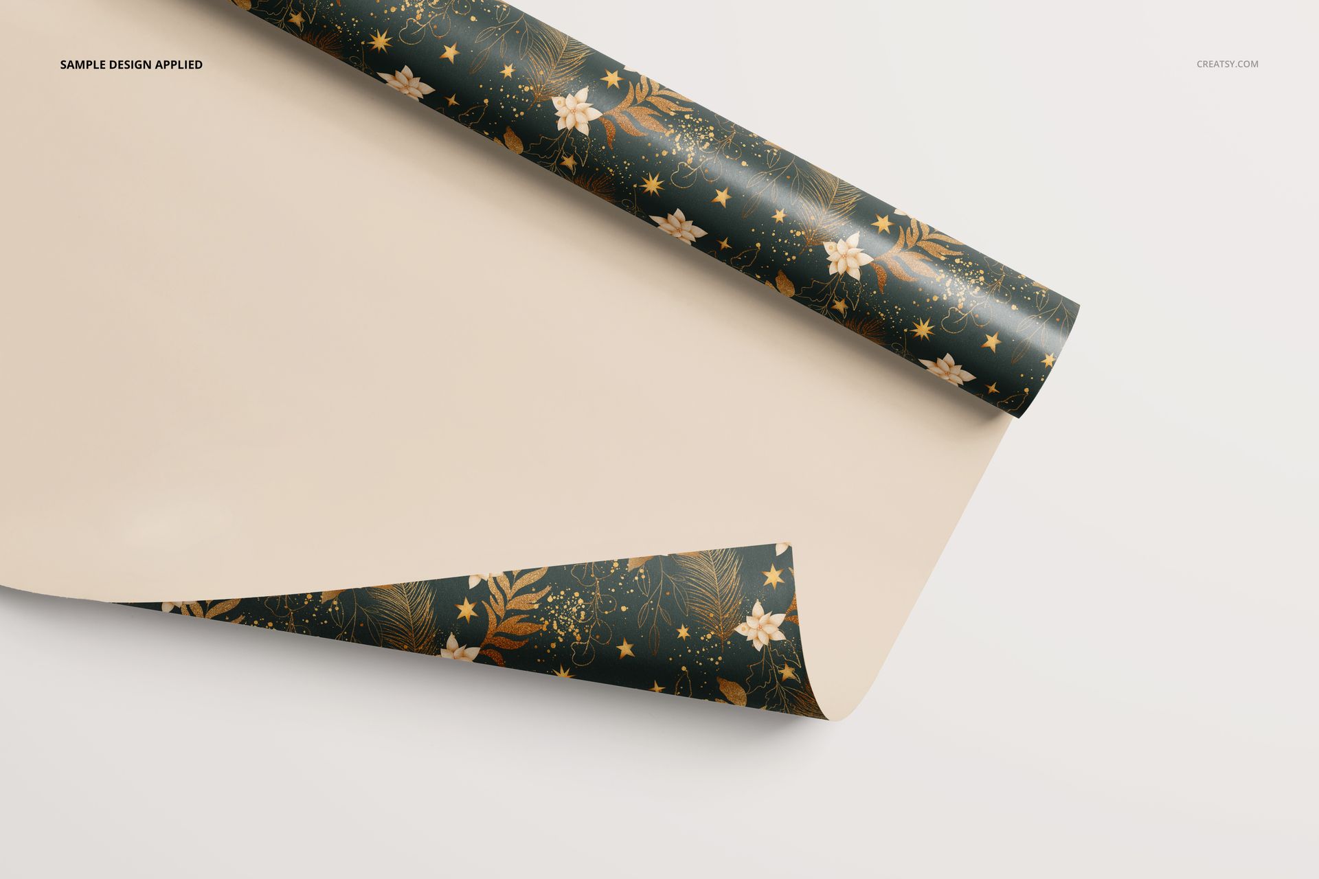 Mockup of gift wrapping paper partially unrolled, featuring a botanical and star pattern on a green base.