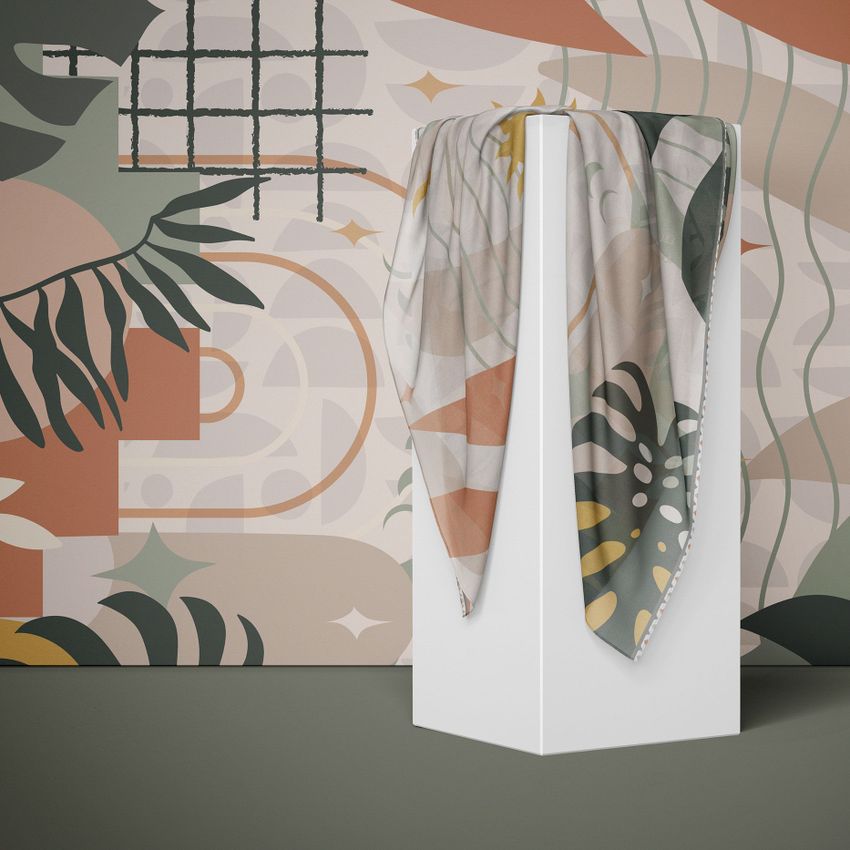 Silk scarf mockup draped over a white pedestal, featuring abstract leaf and geometric patterns in muted earth tones.