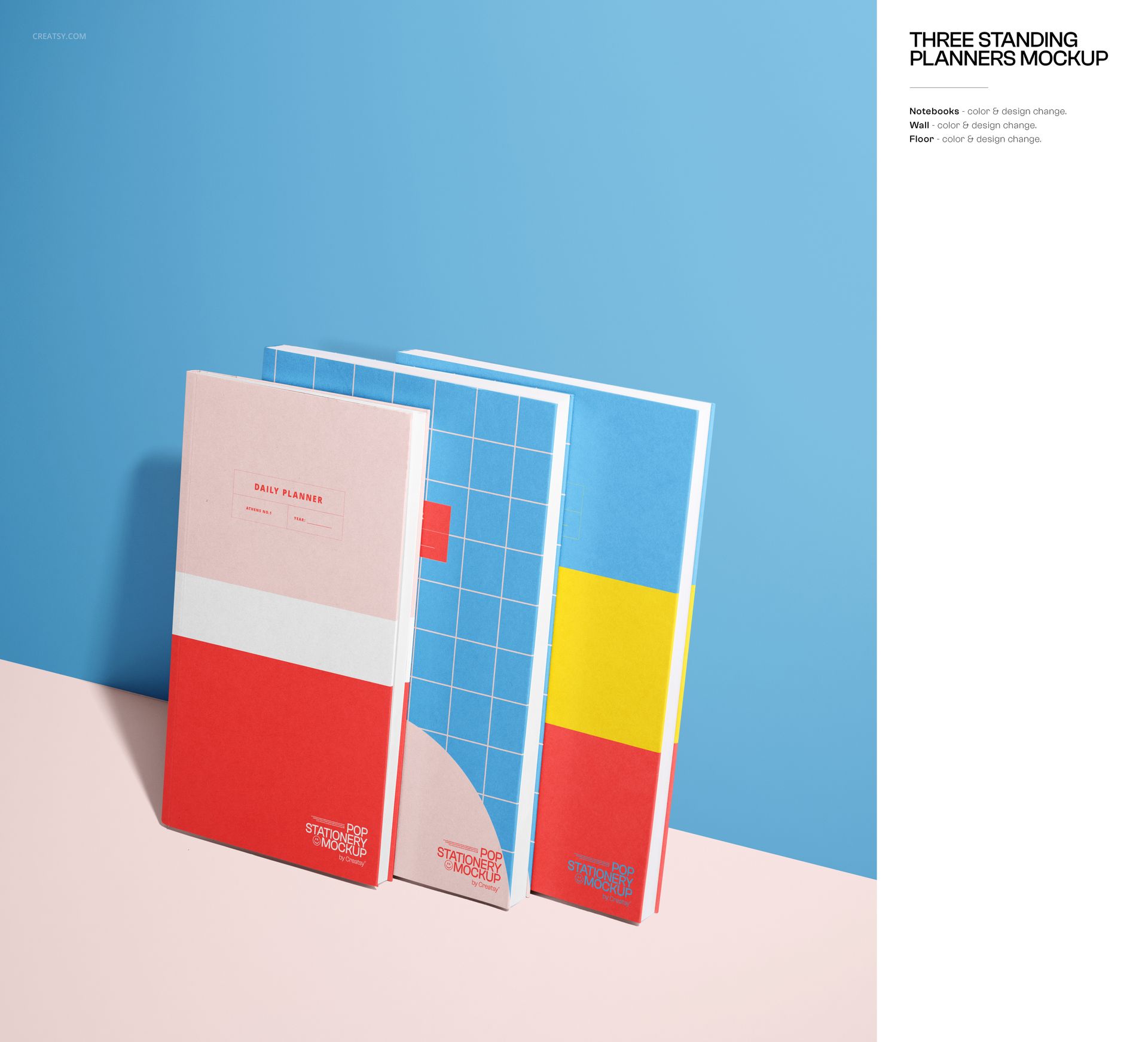 Three standing planners with colorful geometric covers, arranged on a pink surface against a blue background, front view.