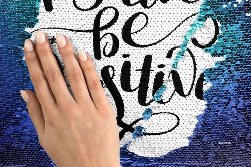 Front view of a mermaid sequin pillow mockup, partially revealed text beneath brushed blue and white sequins.