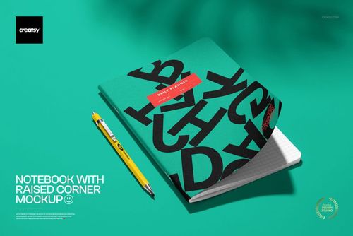 Notebook PSD mockup with a raised corner, black letter pattern on green cover, and a yellow pen on a green background.
