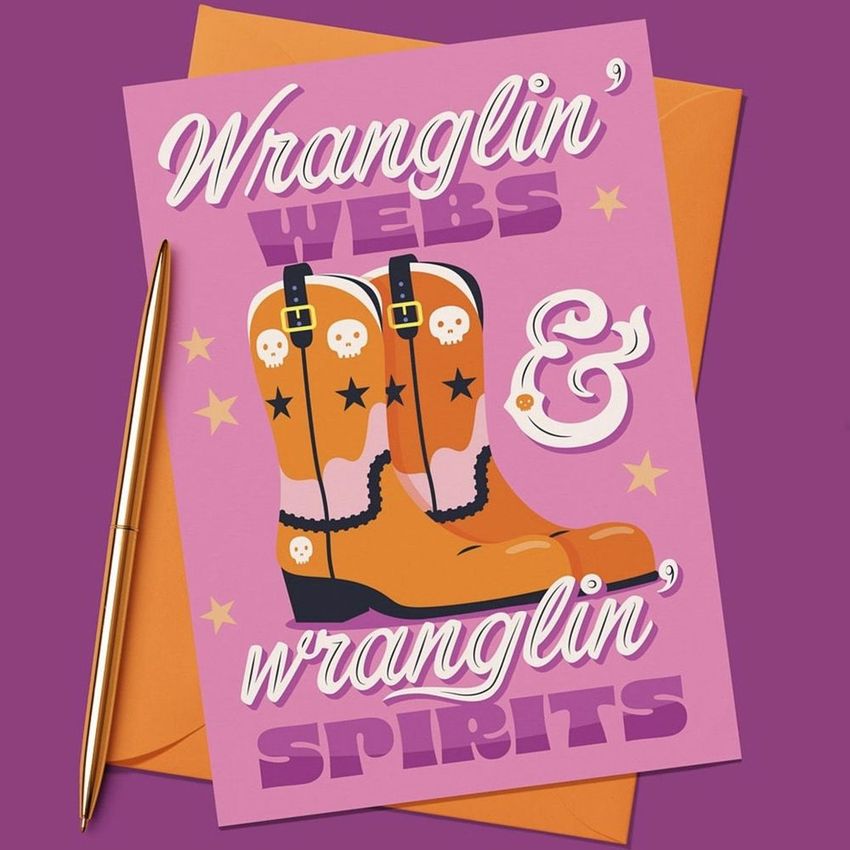 A5 card mockup featuring illustrated cowboy boots with skull designs, bold text overlay, and an orange envelope on a purple background.