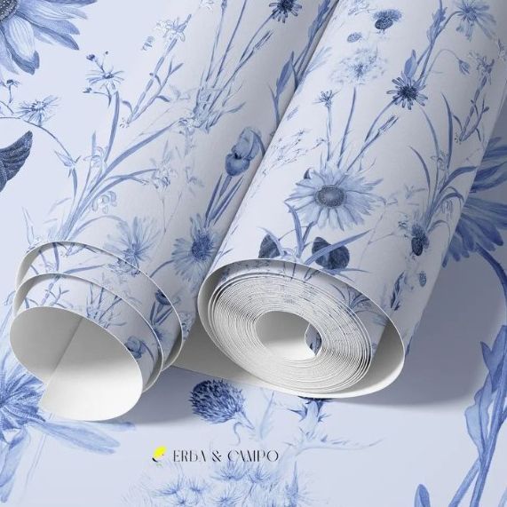 Paper wallpaper mockup featuring two rolled sheets with blue floral illustrations on a light background, viewed from above.