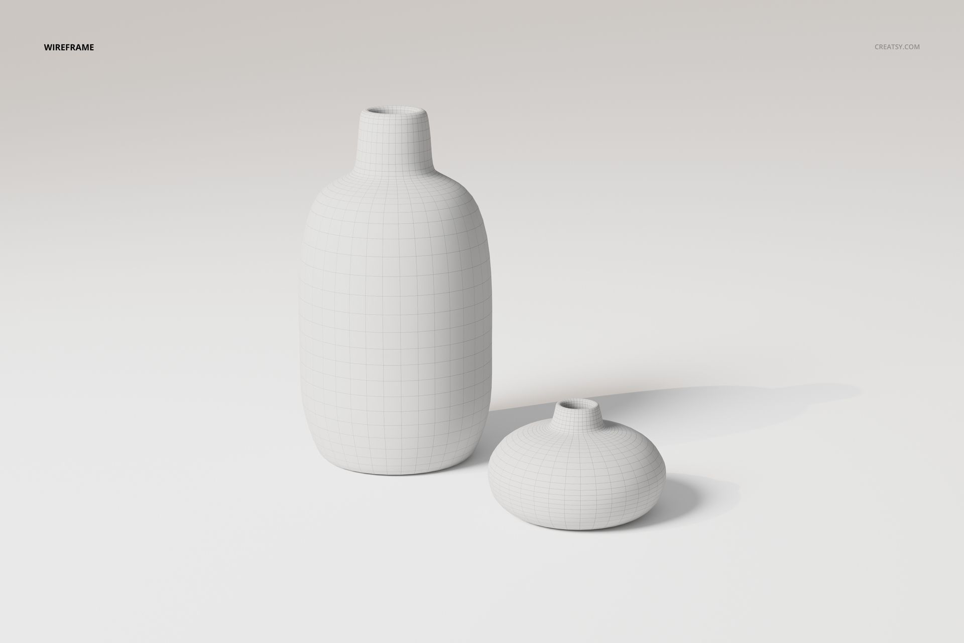 Front view of two ceramic flower vases in white, one tall and cylindrical, one short and rounded, on a plain surface.