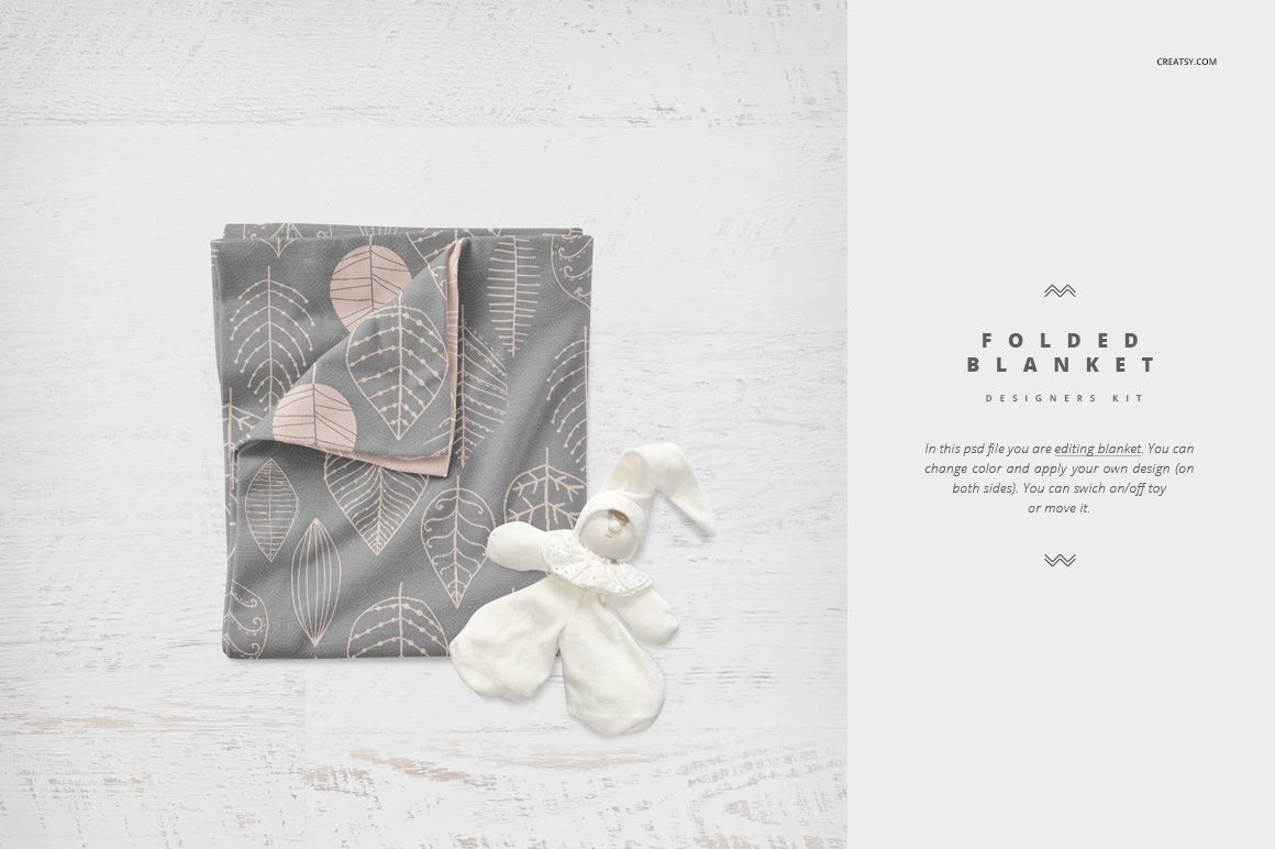 Gray and pale pink patterned crib blanket mockup displayed folded, accompanied by a white plush bunny on a light wood background.