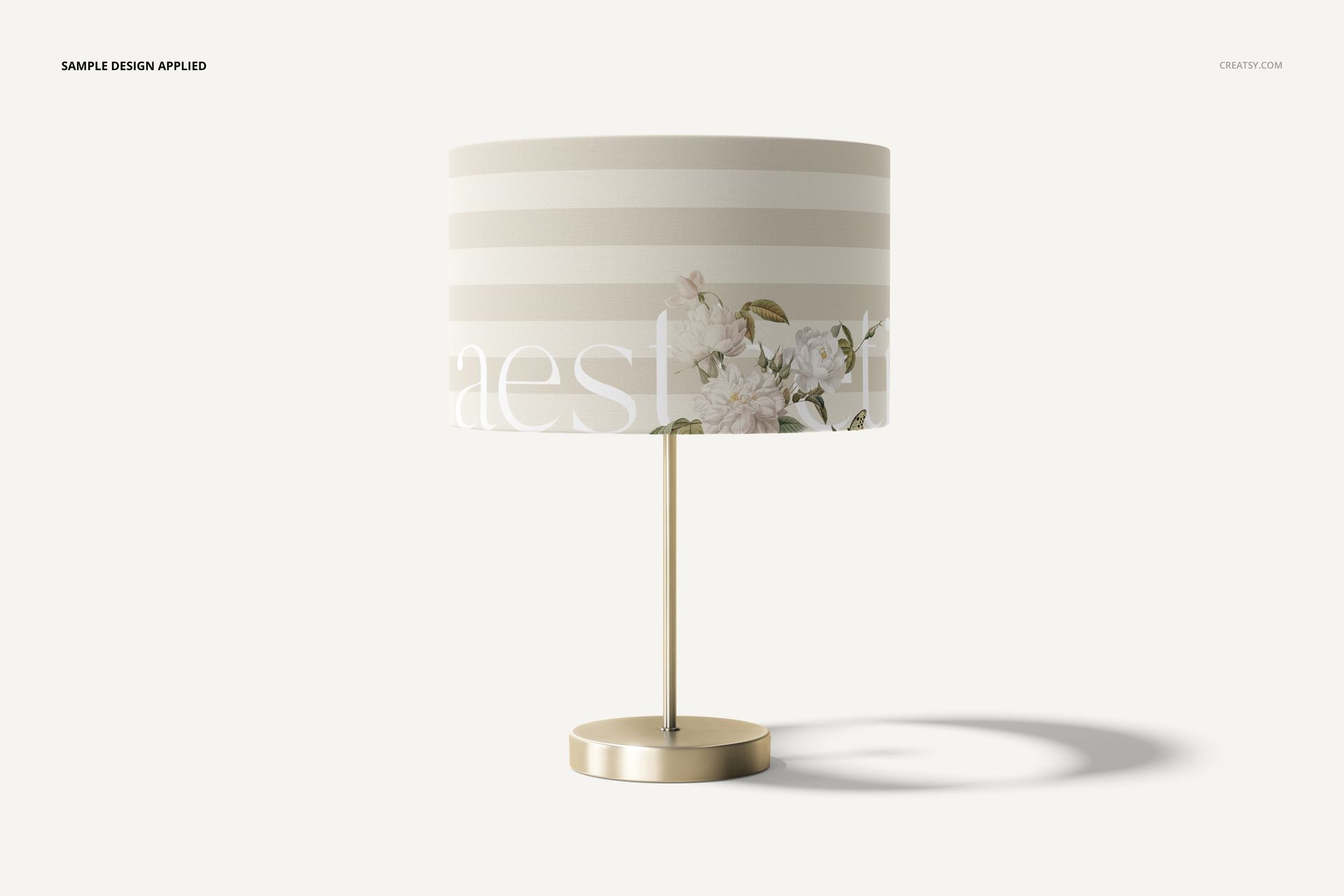 Lamp shade mockup with a cylindrical shape, featuring beige horizontal stripes and floral accents, front view on white background.