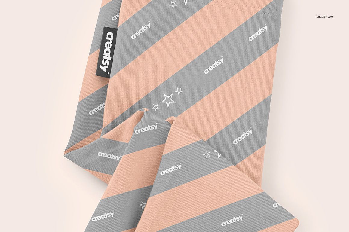 Baby leggings mockup featuring diagonal peach and gray stripes with small star accents, shown in a close-up top view.