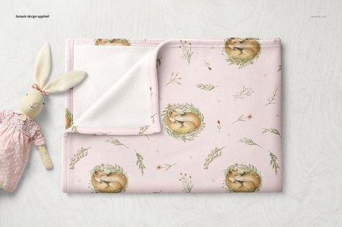 Soft fleece baby blanket mockup with pink background, fox and leaf pattern, shown folded on a light surface.