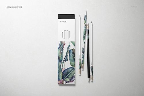 Pencil box mockup featuring a white box with green leaf illustrations and three matching pencils beside it.