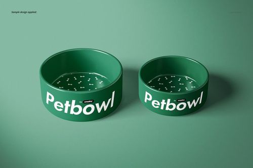 Two green pet bowls with white bone patterns inside, shown from a front angle on a matching green surface.