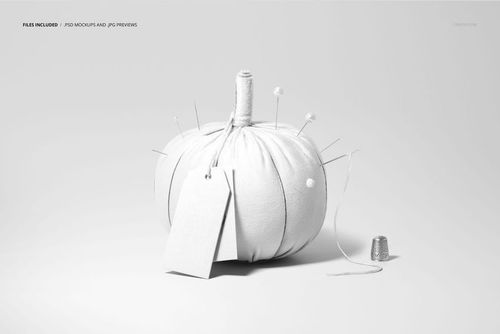 Front view of a fabric pumpkin mockup with sewing needles, pins, a blank tag, and a thimble on a light background.