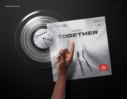 PSD mockup showing a clear vinyl record in hand with an album cover displaying modern monochrome artwork.