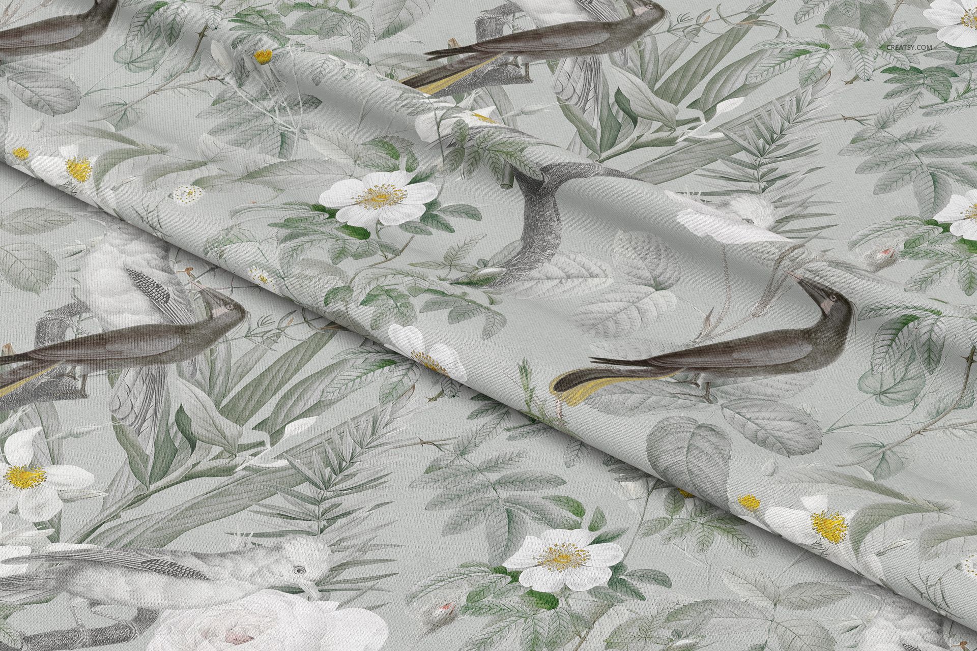 Close-up of polyester curtain fabric mockup displaying a detailed design with birds, foliage, and blooming white flowers.