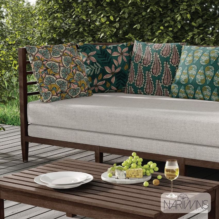 Outdoor scene sofa mockup featuring a wooden-framed sofa with light gray cushions and patterned pillows, set on a deck with greenery in the background.
