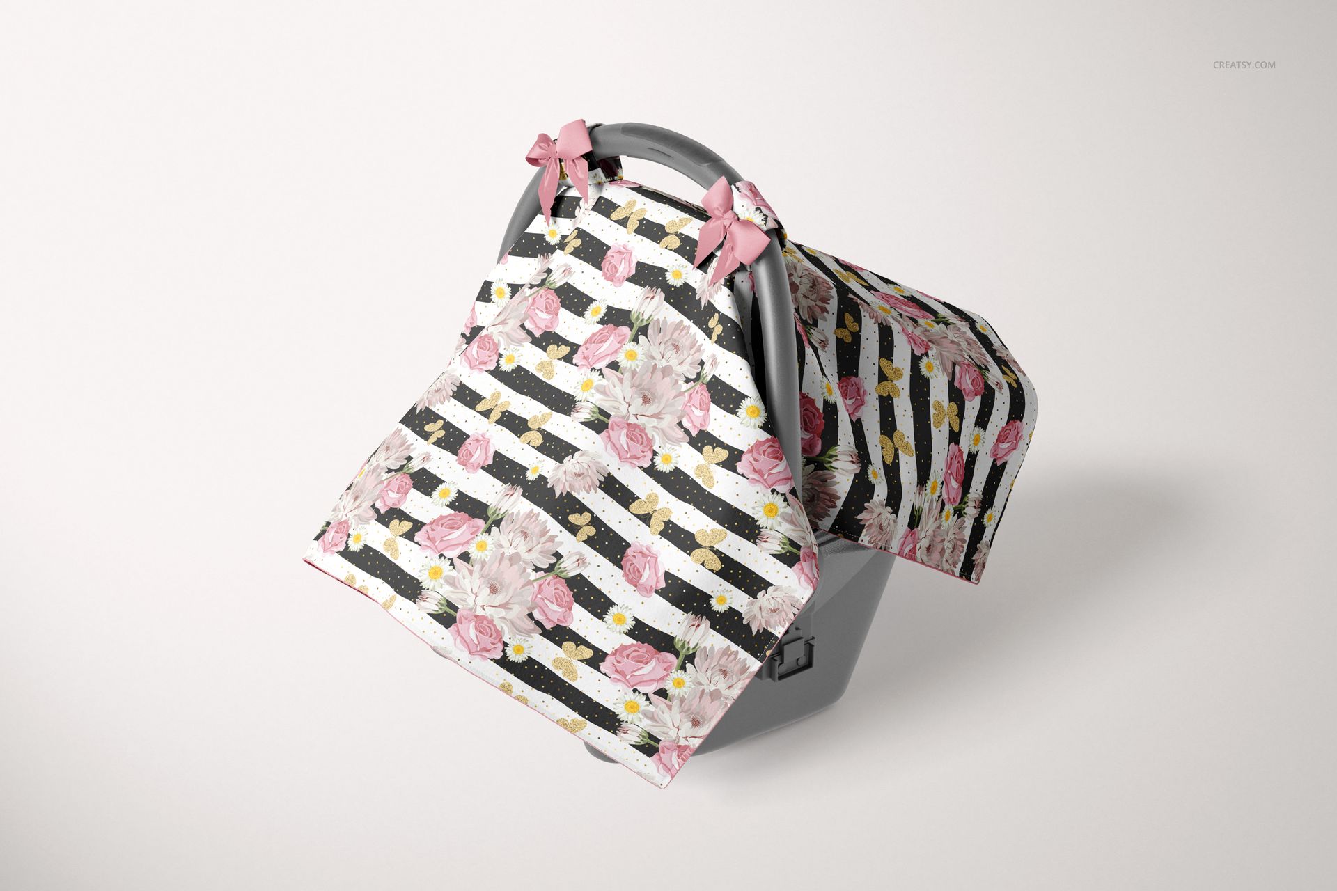 Mockup of a baby car seat canopy cover featuring pink flowers and stripes, displayed draped over a gray infant seat.