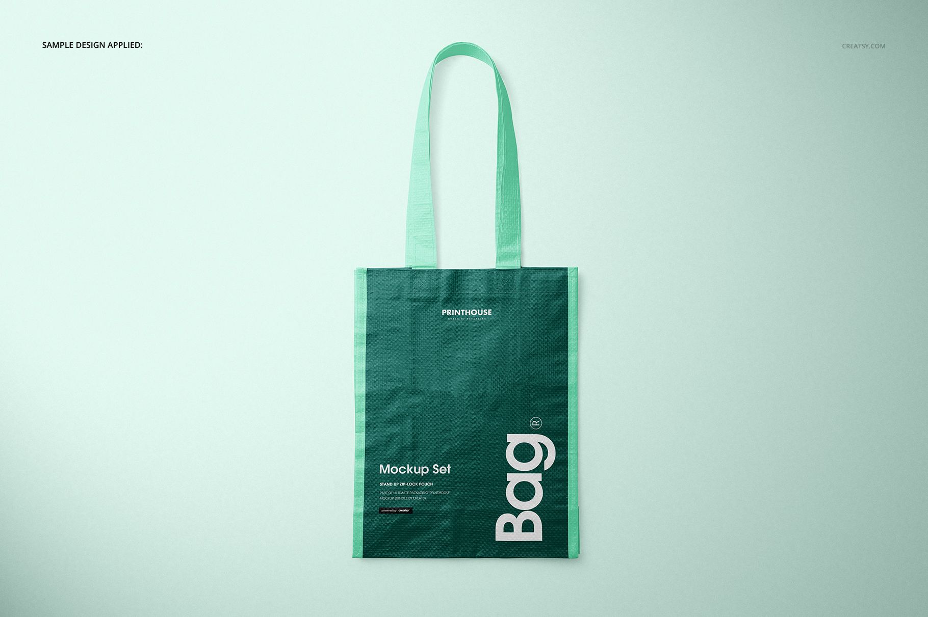 Green woven tote bag mockup displayed upright against a pale backdrop, showing handle and printed design details.