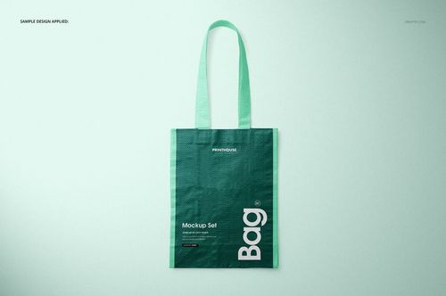 Green woven tote bag mockup displayed upright against a pale backdrop, showing handle and printed design details.