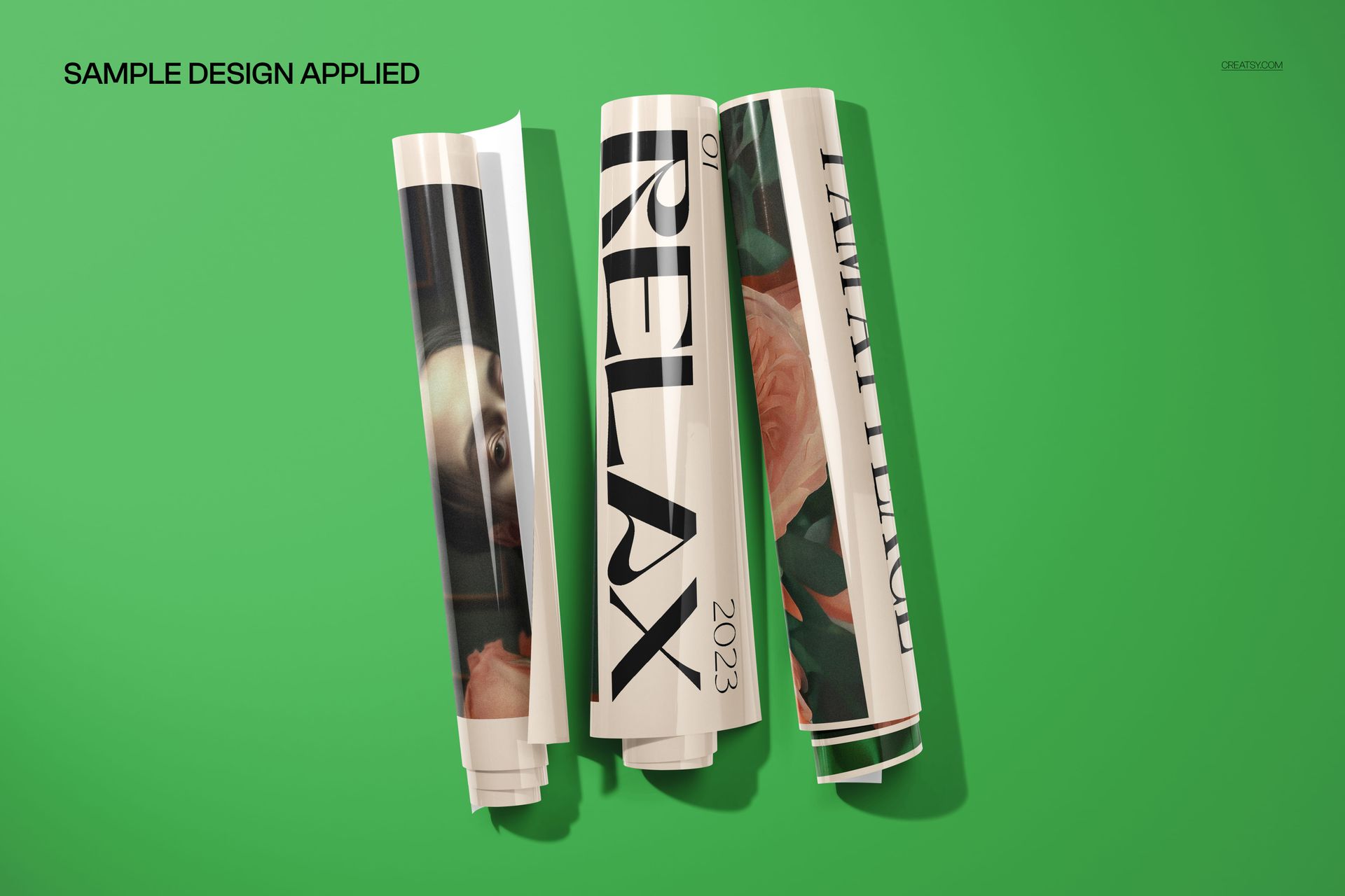 Rolled PVC poster mockup showing three stacked prints with different graphics and shadows on a green backdrop.