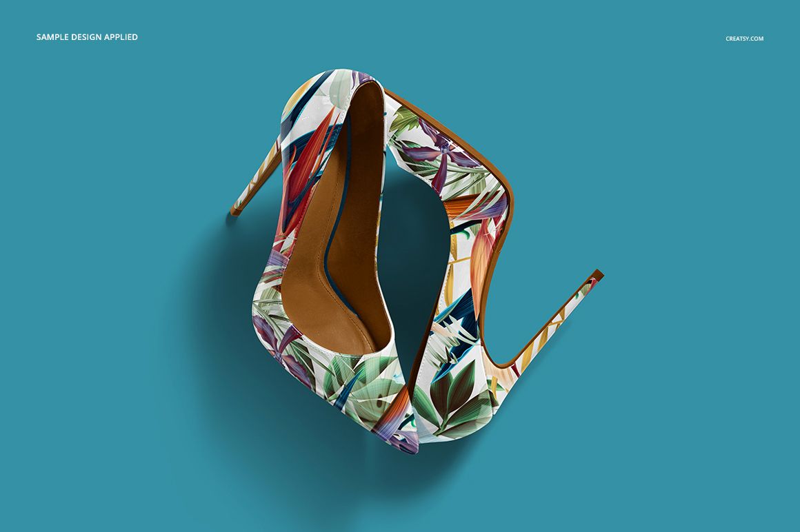PSD mockup of high heels with multicolored leaf print, top perspective against a plain teal backdrop.