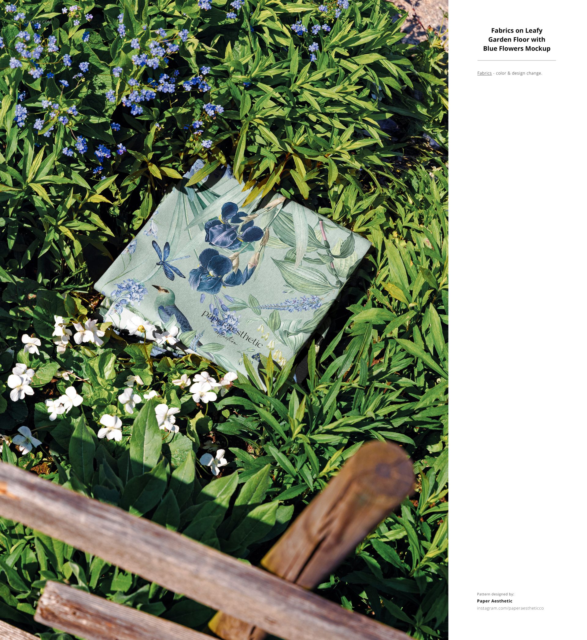 PSD mockup showing a square fabric with botanical and bird print placed in a garden setting surrounded by plants.