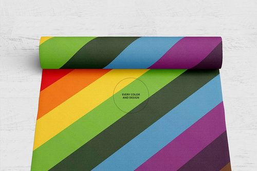 Colorful woven rug mockup featuring bold diagonal stripes in green, yellow, orange, blue, and purple on a white floor.