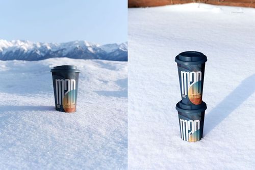 Winter-themed PSD mockup featuring drinkware cups with dark lids and colorful graphics on a snow-covered landscape.