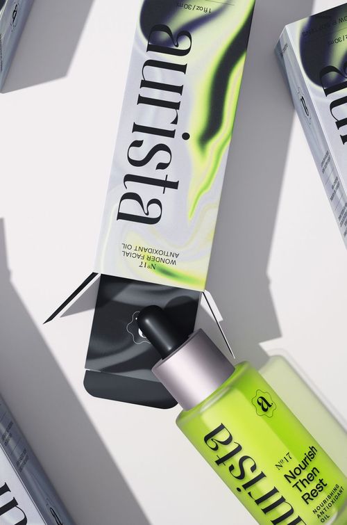 Front view of a dropper bottle and packaging with green and black gradient design, shown in a cosmetics mockup scene.