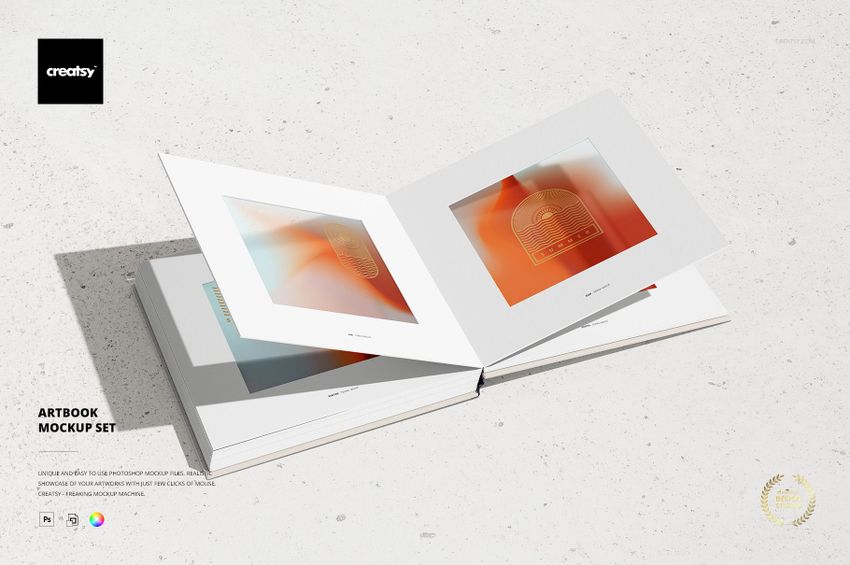 Open artbook mockup set displayed on a light textured surface, featuring abstract orange designs on both pages.