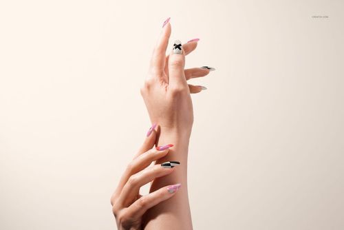 PSD mockup of hands with decorative nail designs in black, white, and pink, photographed from the front on a plain background.
