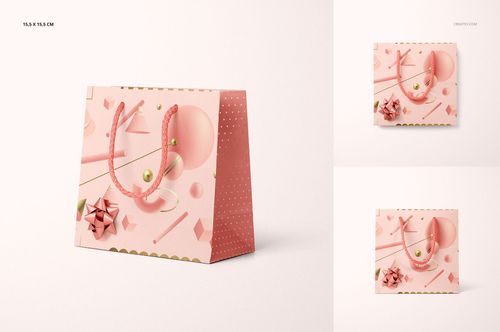 PSD mockup showing a pink gifting paper bag with geometric shapes, gold accents, and pink ribbon handles on a light background.