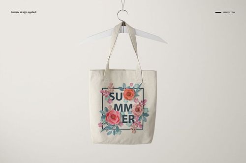 Polyester tote bag mockup displayed on a hanger, with pink and orange flowers framing the word summer.