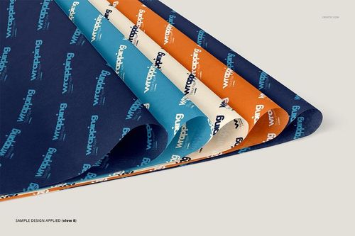 Four sheets of wrapping tissue paper mockup displayed in a layered arrangement, featuring blue, cream, and orange colors with repeating text patterns.
