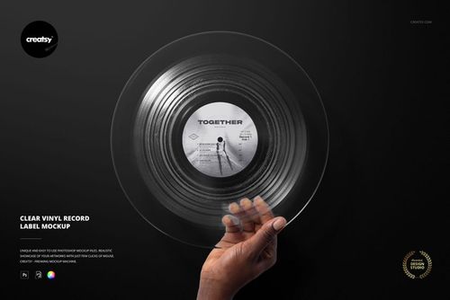 Hand holding a clear vinyl record with a custom label design, shown on a dark background in a front view mockup.